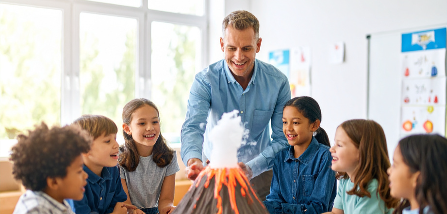 Young students watch a volcano science experiment