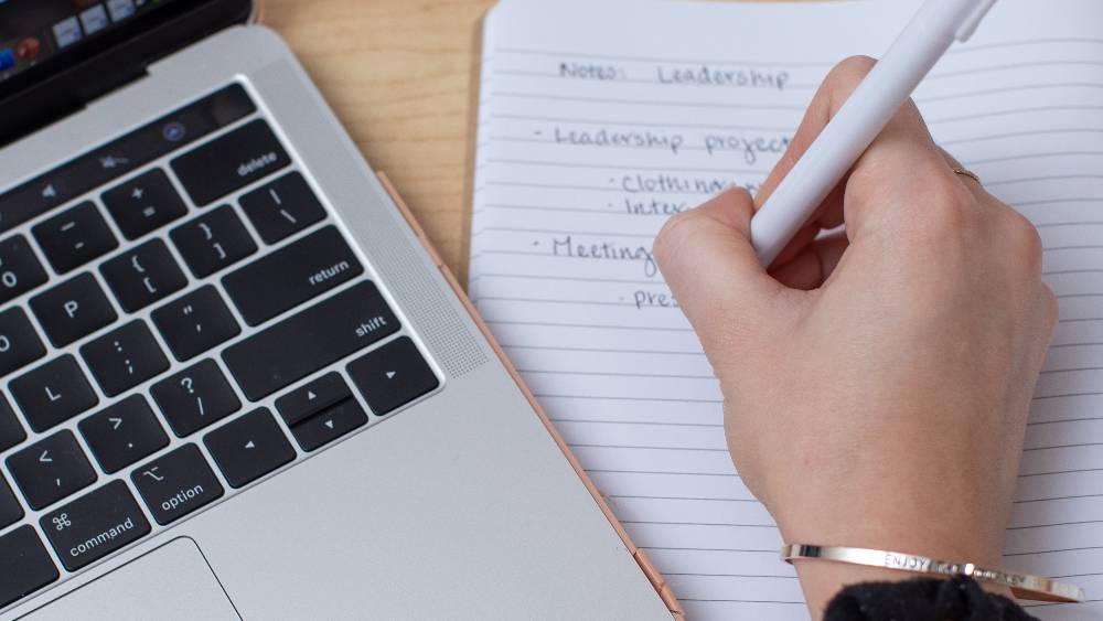 person at table with macbook