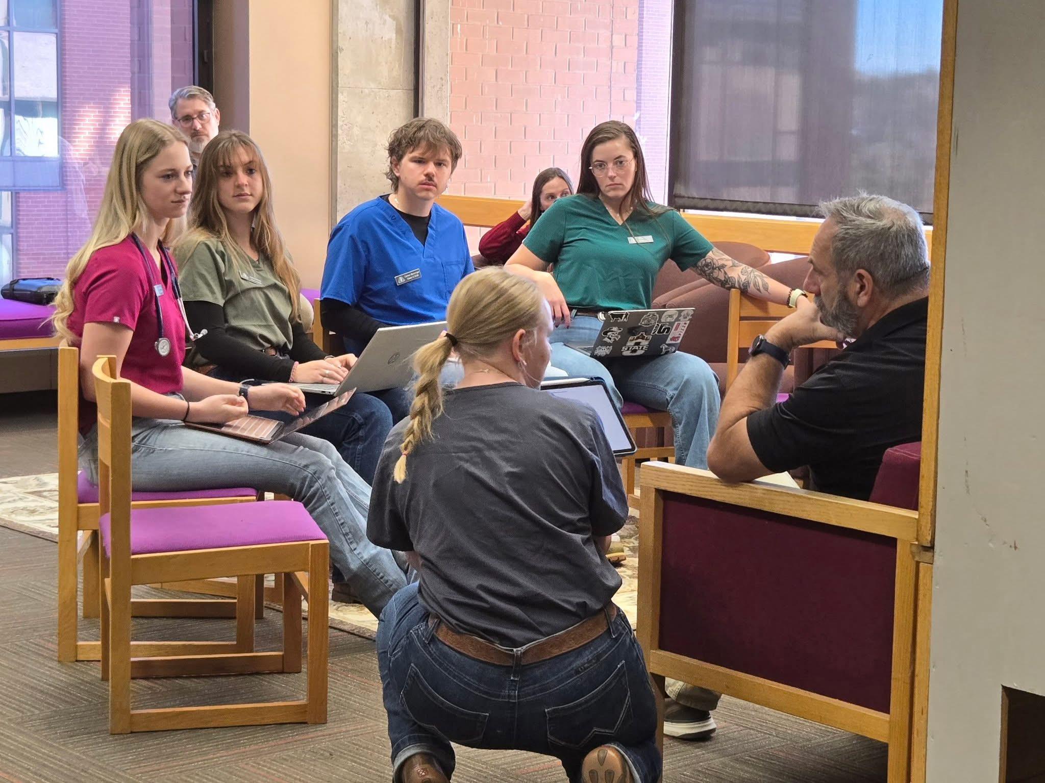 Madi explains a treatment plan to their dairy manager during Diagnostic Challenge 2.