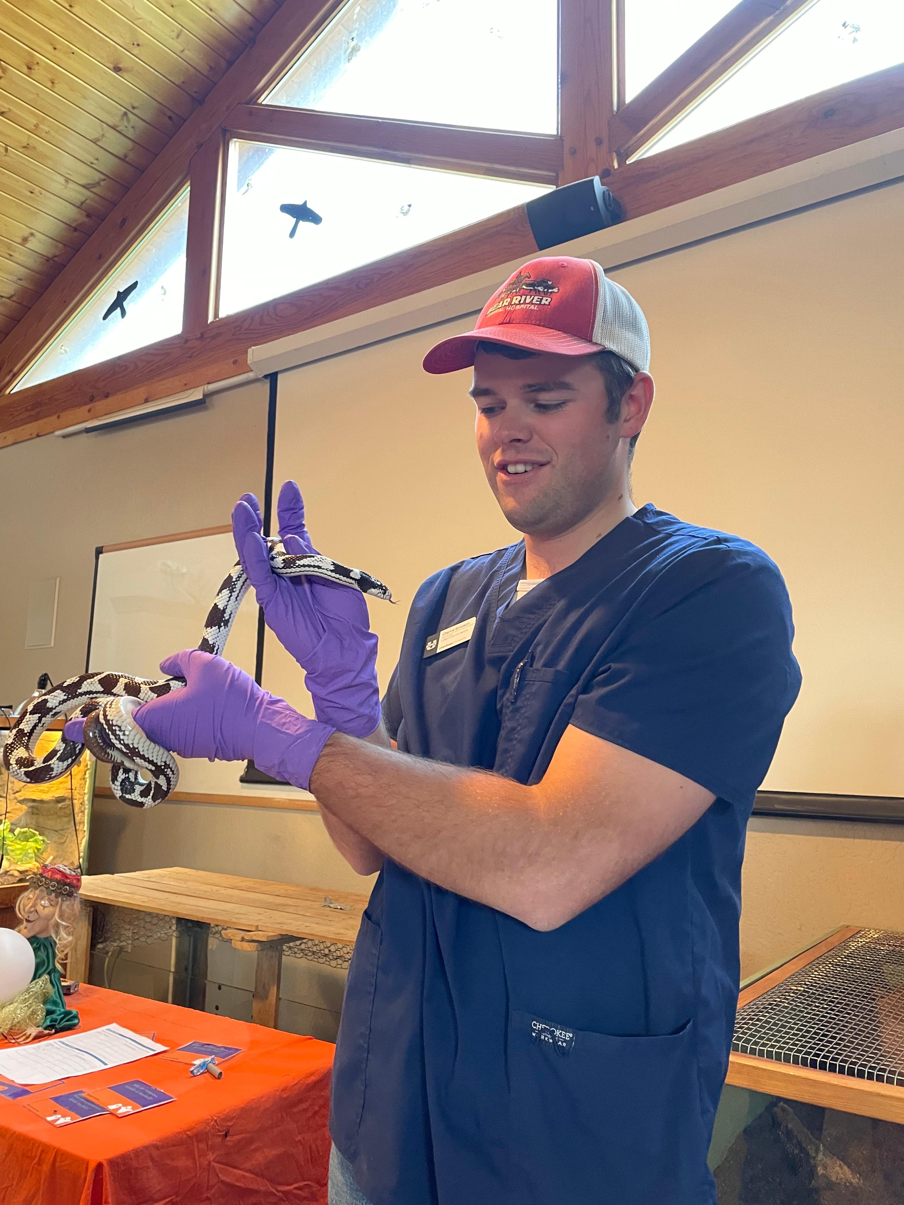 Chance handles a snake at Zootah during a clinical skills lab.