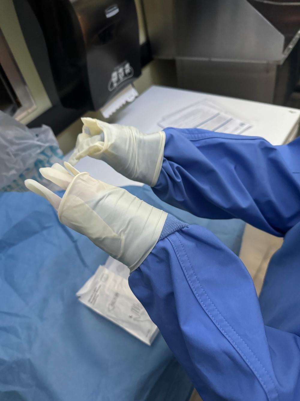 The struggle of trying to put sterile gloves on after a sterile scrub while your hands are still slightly moist.
